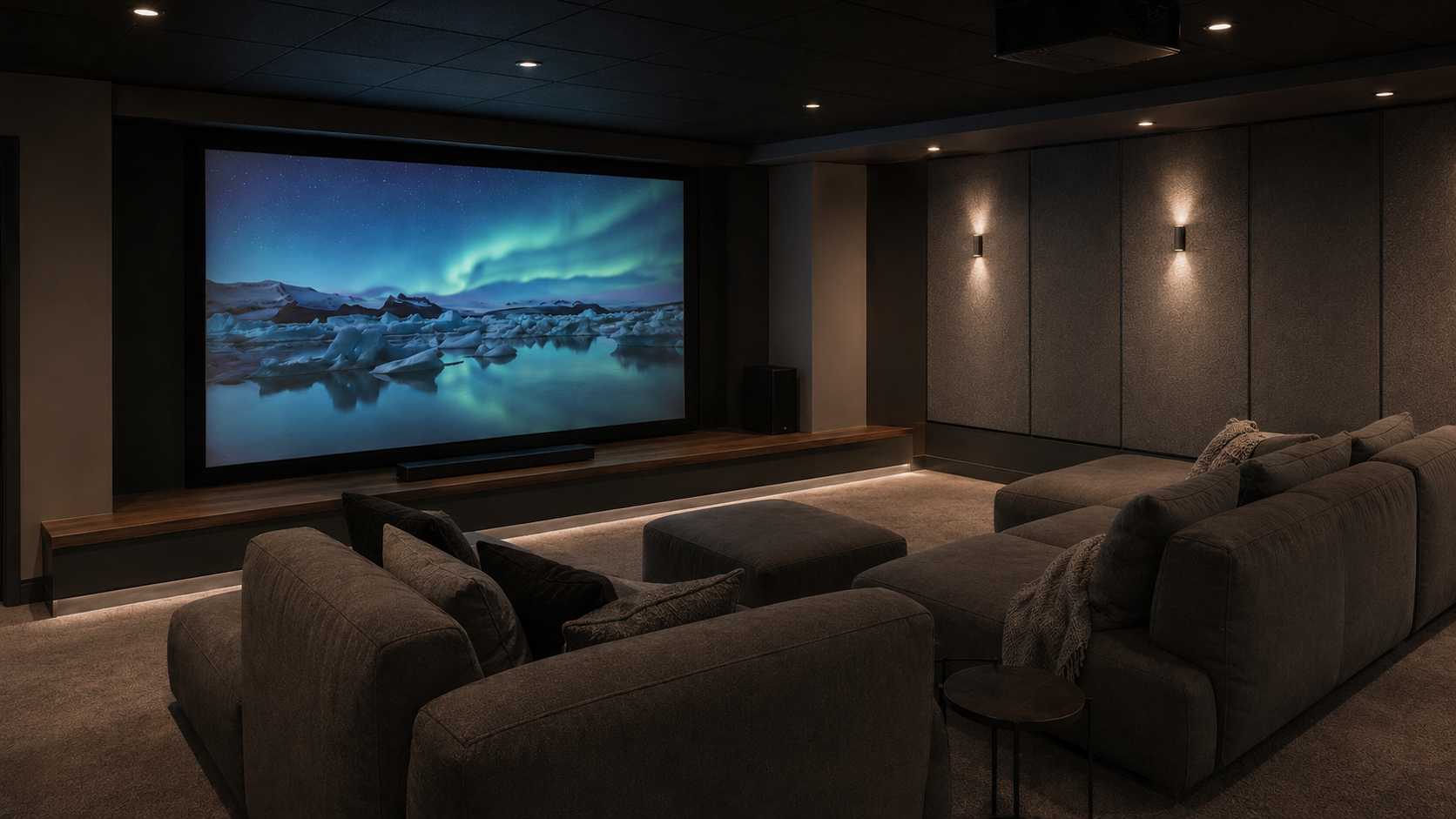 Large-format media room with an aurora scene, acoustic wall panels and relaxed sectional seating