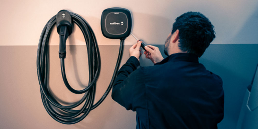 Repairman Working on Home Electric Vehicle Charger | Amplex Technology Services